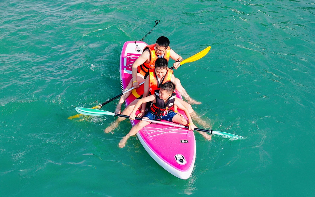 Family paddling on a boat during Langkawi Sunset Cruise.