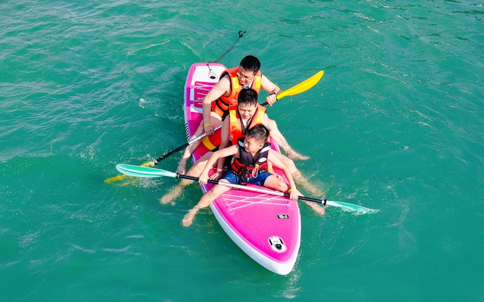 Family paddling on a boat during Langkawi Sunset Cruise.