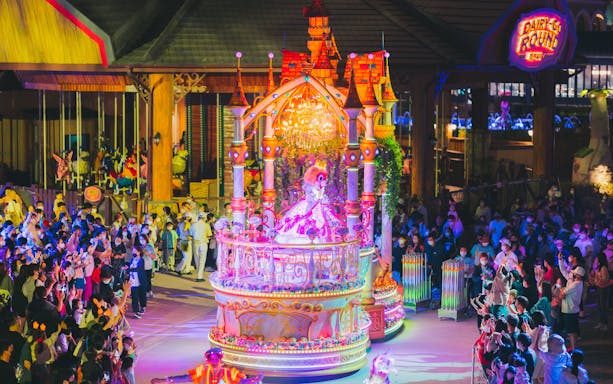 Performance parade at Lotte World Adventure Busan with colorful float and crowd.
