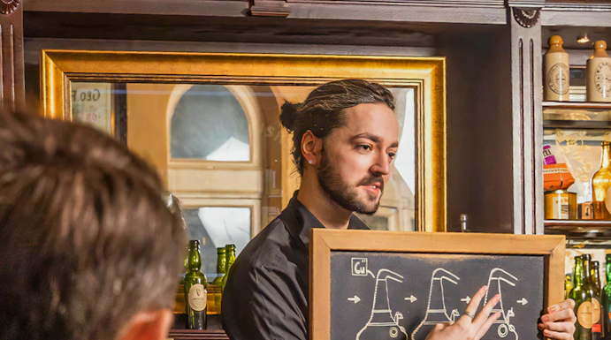 Guide explaining whiskey distillation at Irish Whiskey Museum in Dublin, Ireland.