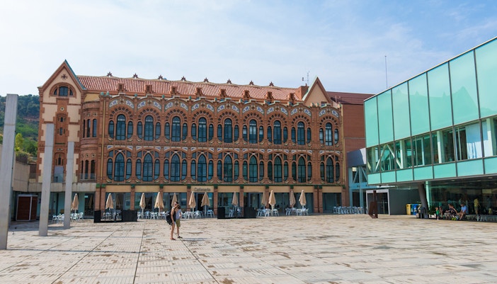 Cosmo Caixa Barcelona science museum exterior with modern architecture and glass facade.