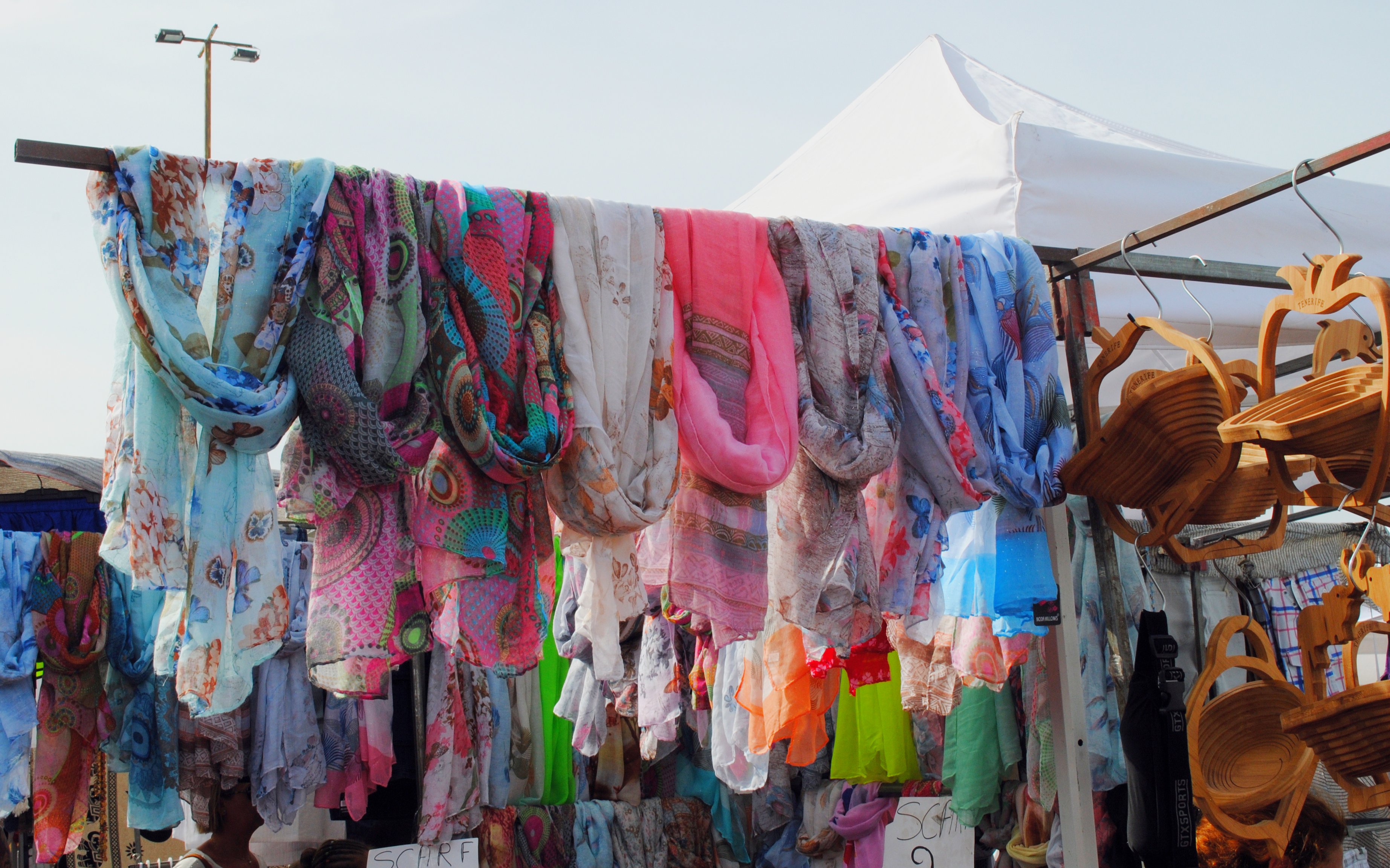 Colorful fabric scarves displayed at a market stall in Tenerife.