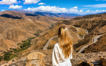 Woman overlooking Tizi n'Tichka mountain pass in Morocco's High Atlas Mountains, Marrakech.