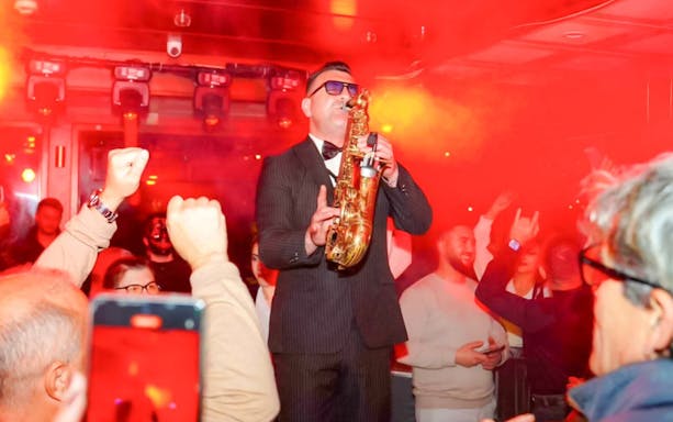 Saxophonist performing on a lively dinner cruise in Istanbul.