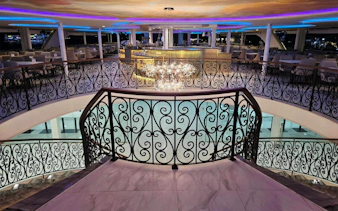 Elegant dining area on Noah Cruise ship in Bangkok with ornate railings and chandelier.