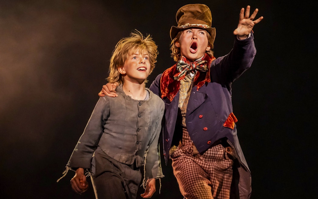 Two actors on stage in a scene from the musical "Oliver!