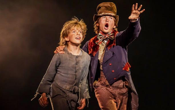 Two actors on stage in a scene from the musical "Oliver!