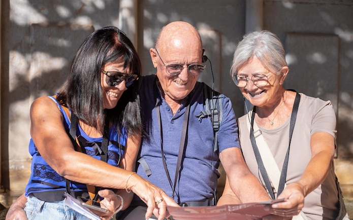 Visitors using audio guides at Knossos Palace Archaeological Site.