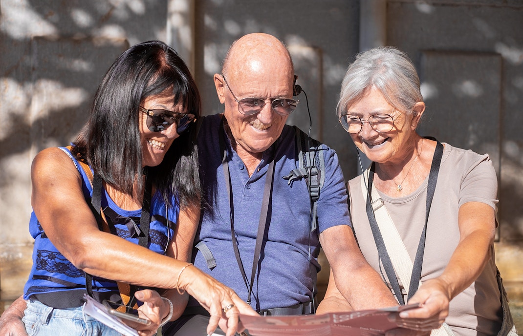 Visitors using audio guides at Knossos Palace Archaeological Site.