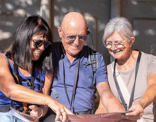 Visitors using audio guides at Knossos Palace Archaeological Site.