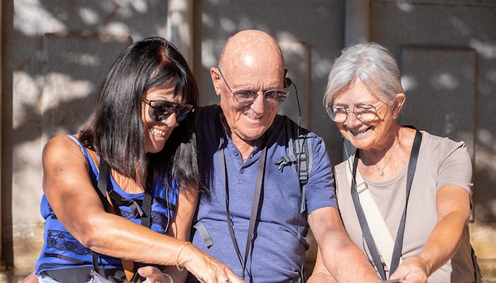 Visitors using audio guides at Knossos Palace Archaeological Site.