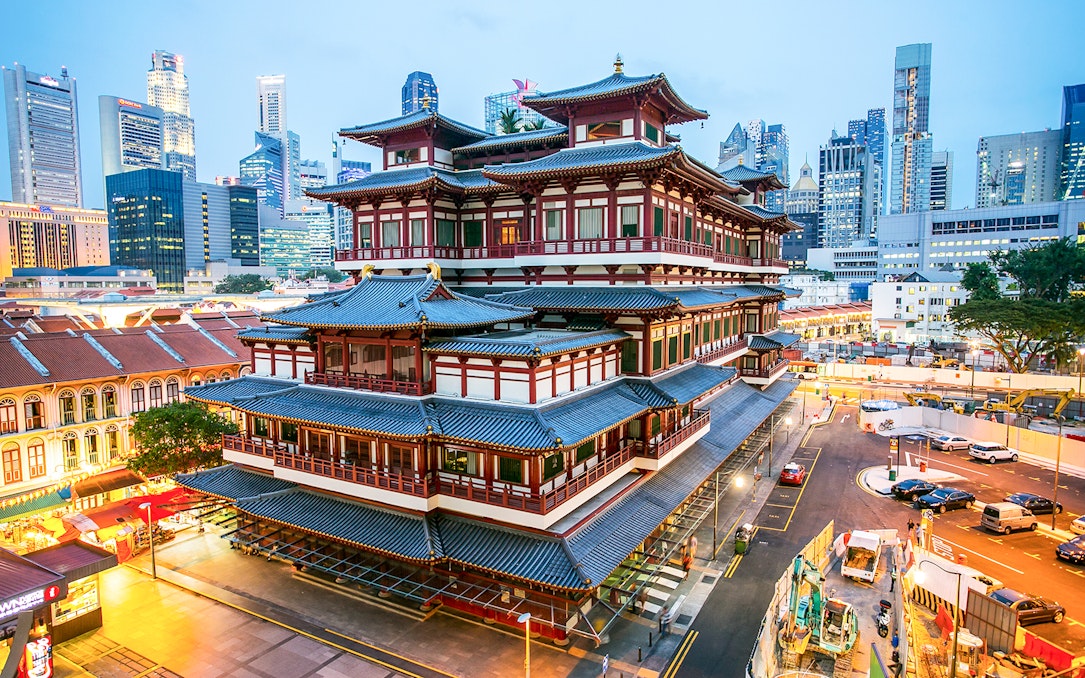 Buddha Tooth Relic Temple in Chinatown, Singapore with city skyline in the background.