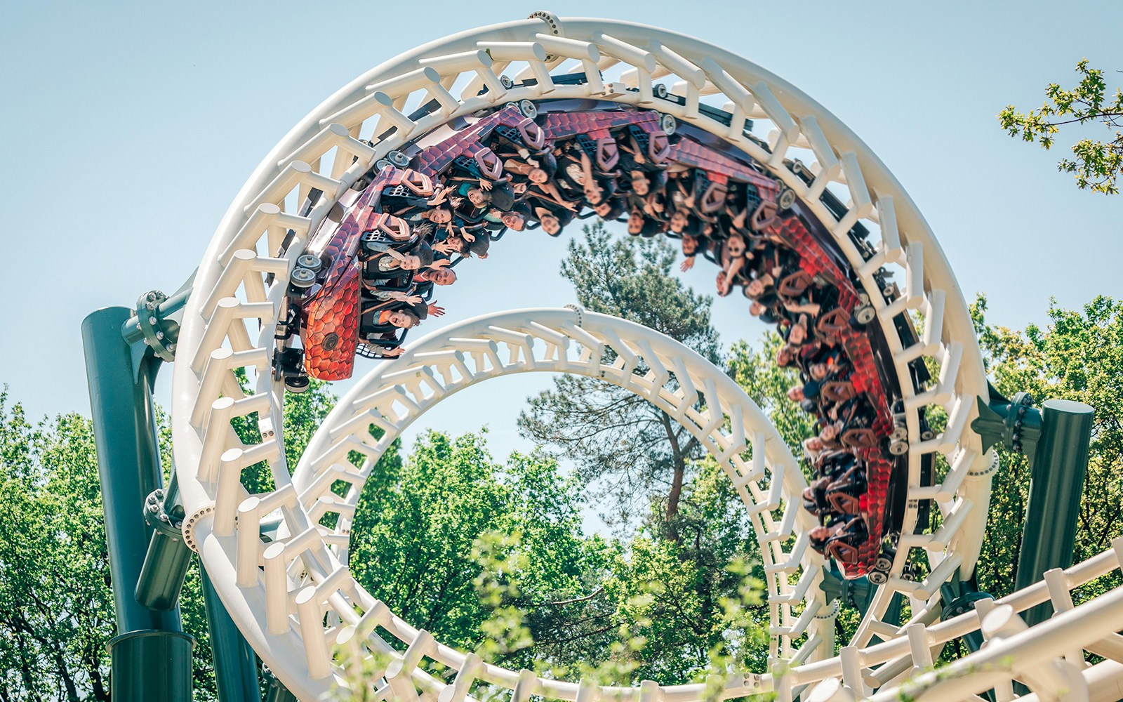 Roller coaster loop at Efteling theme park, Netherlands, with riders enjoying the thrill.