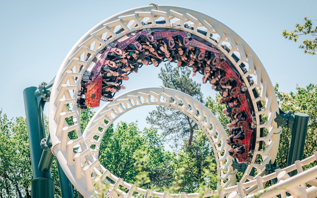Roller coaster loop at Efteling theme park, Netherlands, with riders enjoying the thrill.