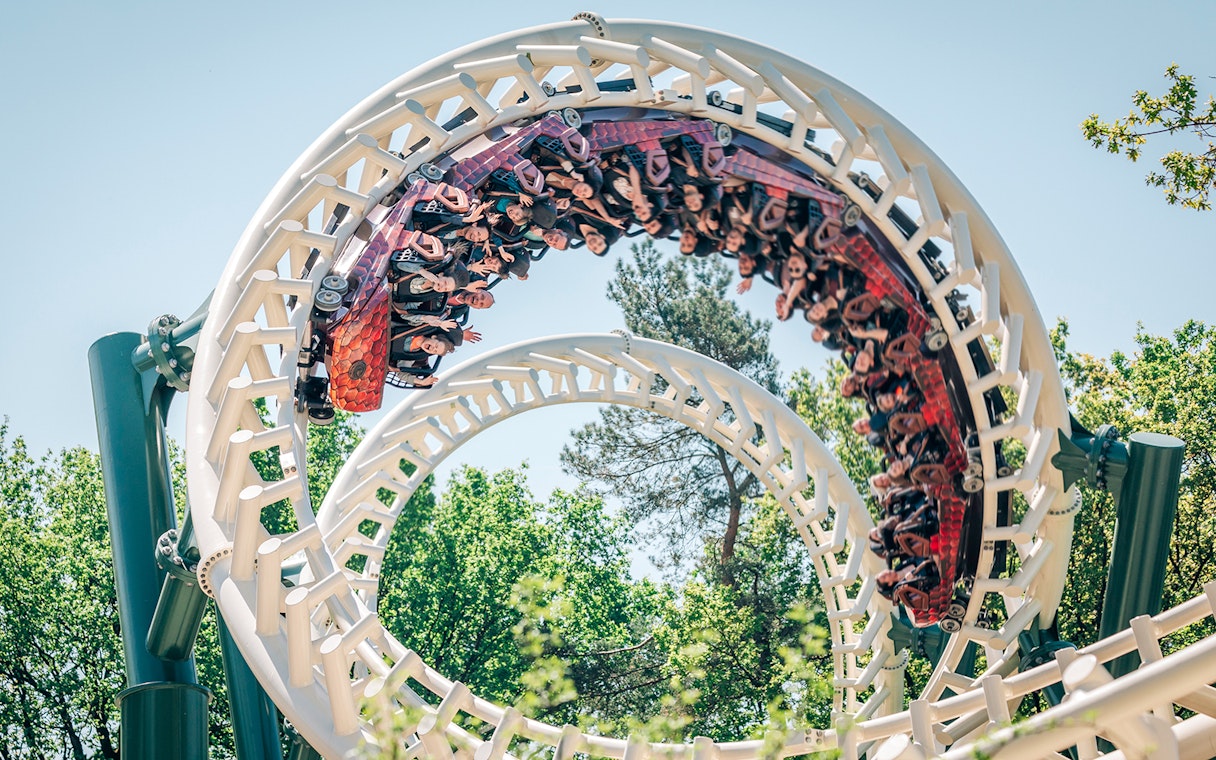 Roller coaster loop at Efteling theme park, Netherlands, with riders enjoying the thrill.