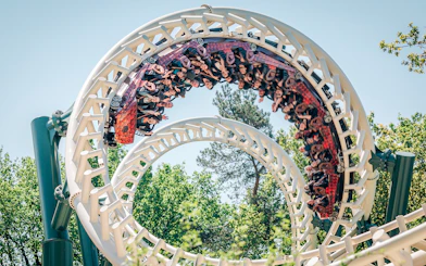 Roller coaster loop at Efteling theme park, Netherlands, with riders enjoying the thrill.