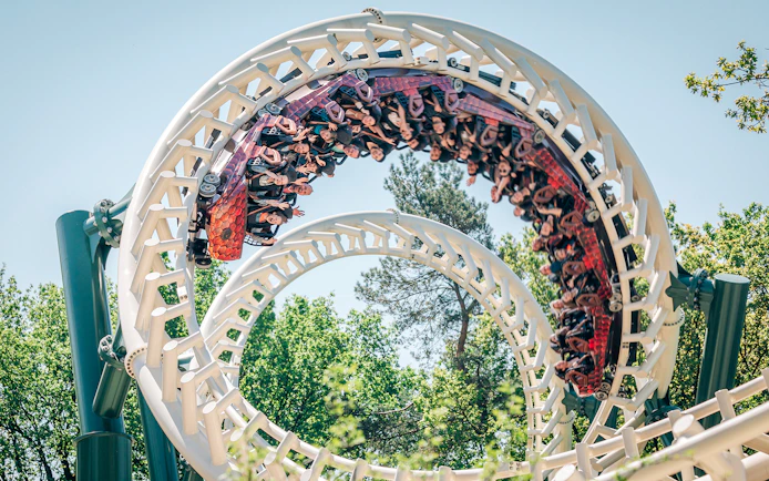 Roller coaster loop at Efteling theme park, Netherlands, with riders enjoying the thrill.