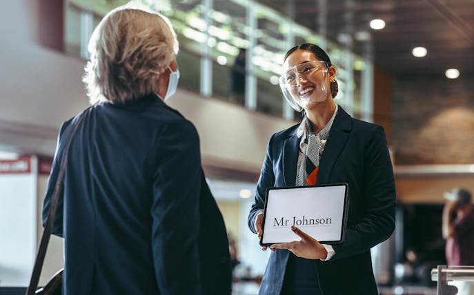 Airport greeter holding a sign for Mr. Johnson at Katowice Pyrzowice airport.