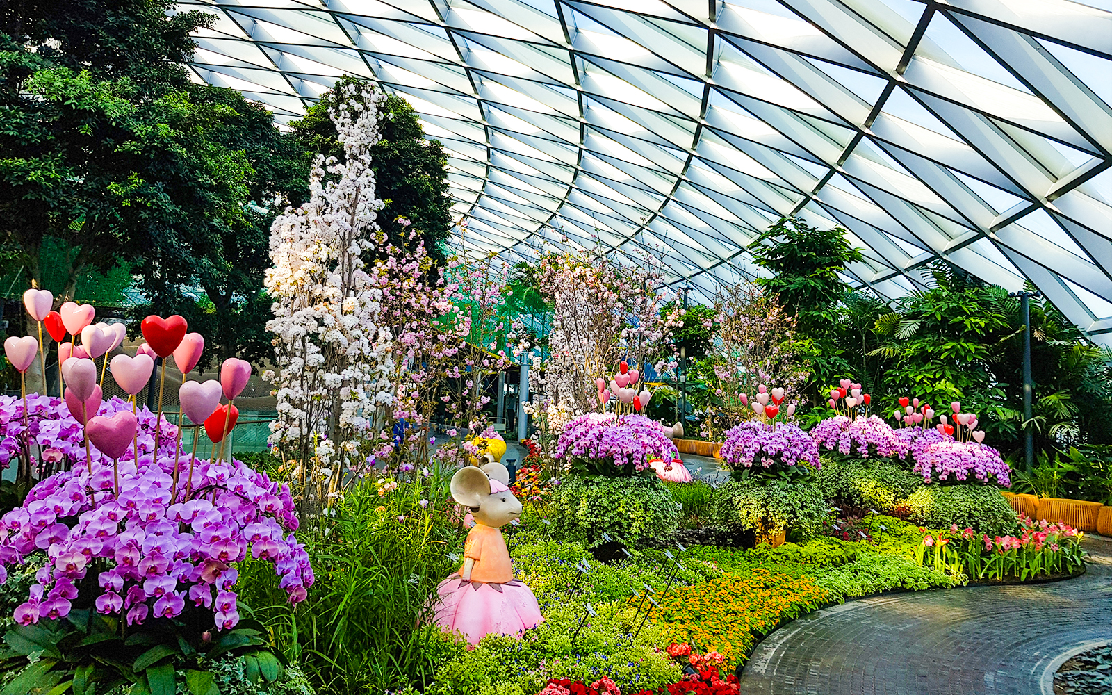 Petal Garden at Canopy Park, Jewel Changi, featuring vibrant flowers and whimsical sculptures.