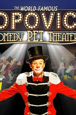 Performer in top hat with animals at Popovich Comedy Pet Theater.