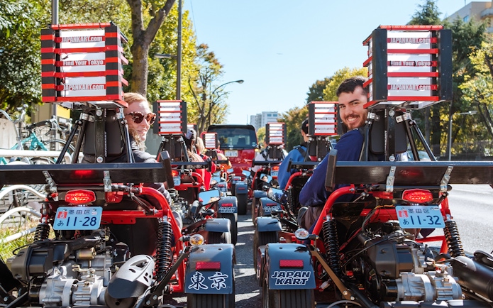 People driving go-karts on Shibuya Shinjuku Tour in Tokyo, Japan.