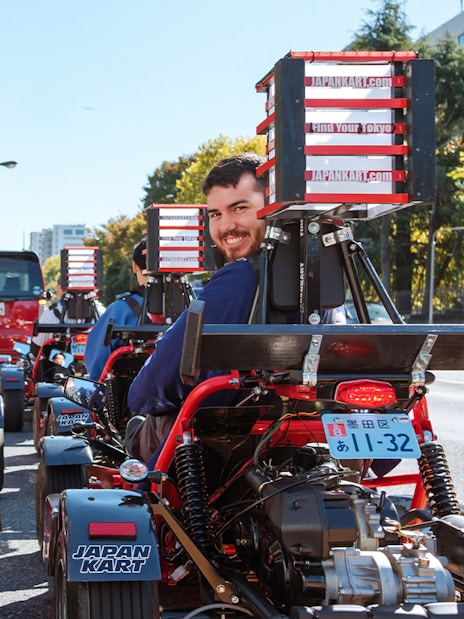 People driving go-karts on Shibuya Shinjuku Tour in Tokyo, Japan.
