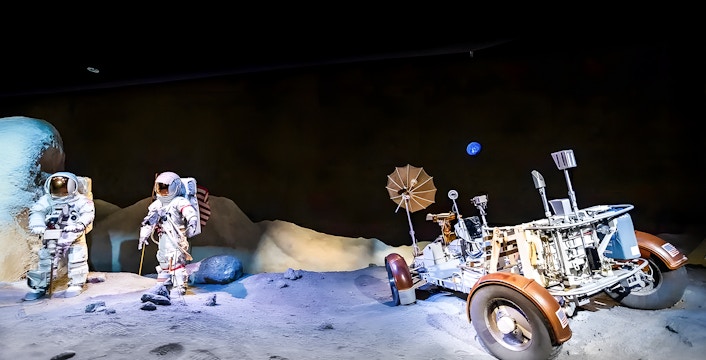 Astronauts and rover in an exhibit at Houston Space Center