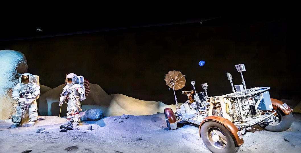 Astronauts and rover in an exhibit at Houston Space Center