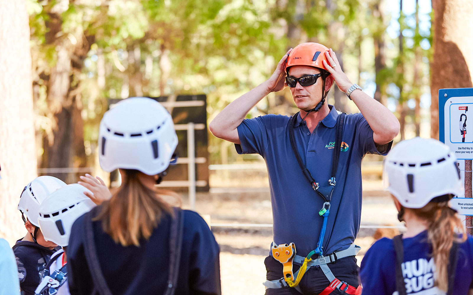 Instructor guiding group on safety gear at Ludlow Tuart Forest, Western Australia.