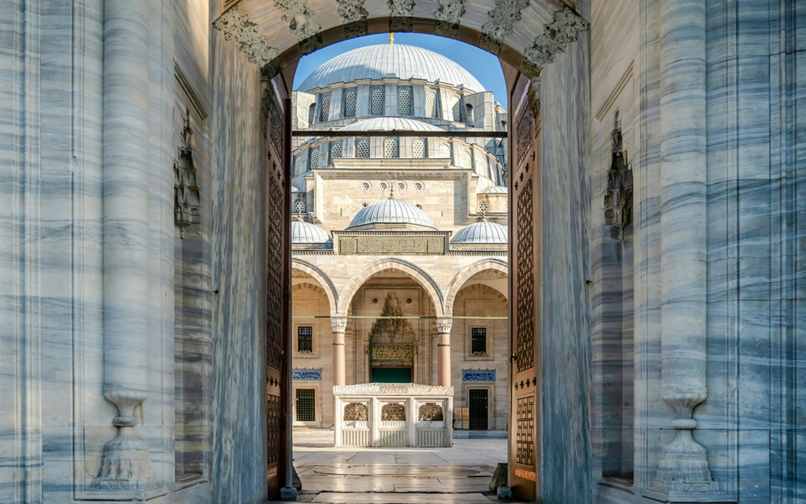 Courtyard view through the entrance of Süleymaniye Mosque, Istanbul.