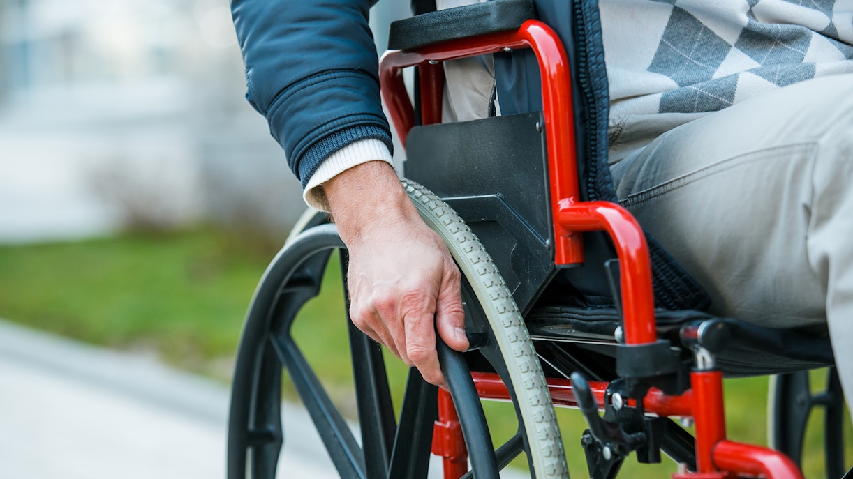 Man in wheelchair exploring a museum exhibit, highlighting accessibility features.