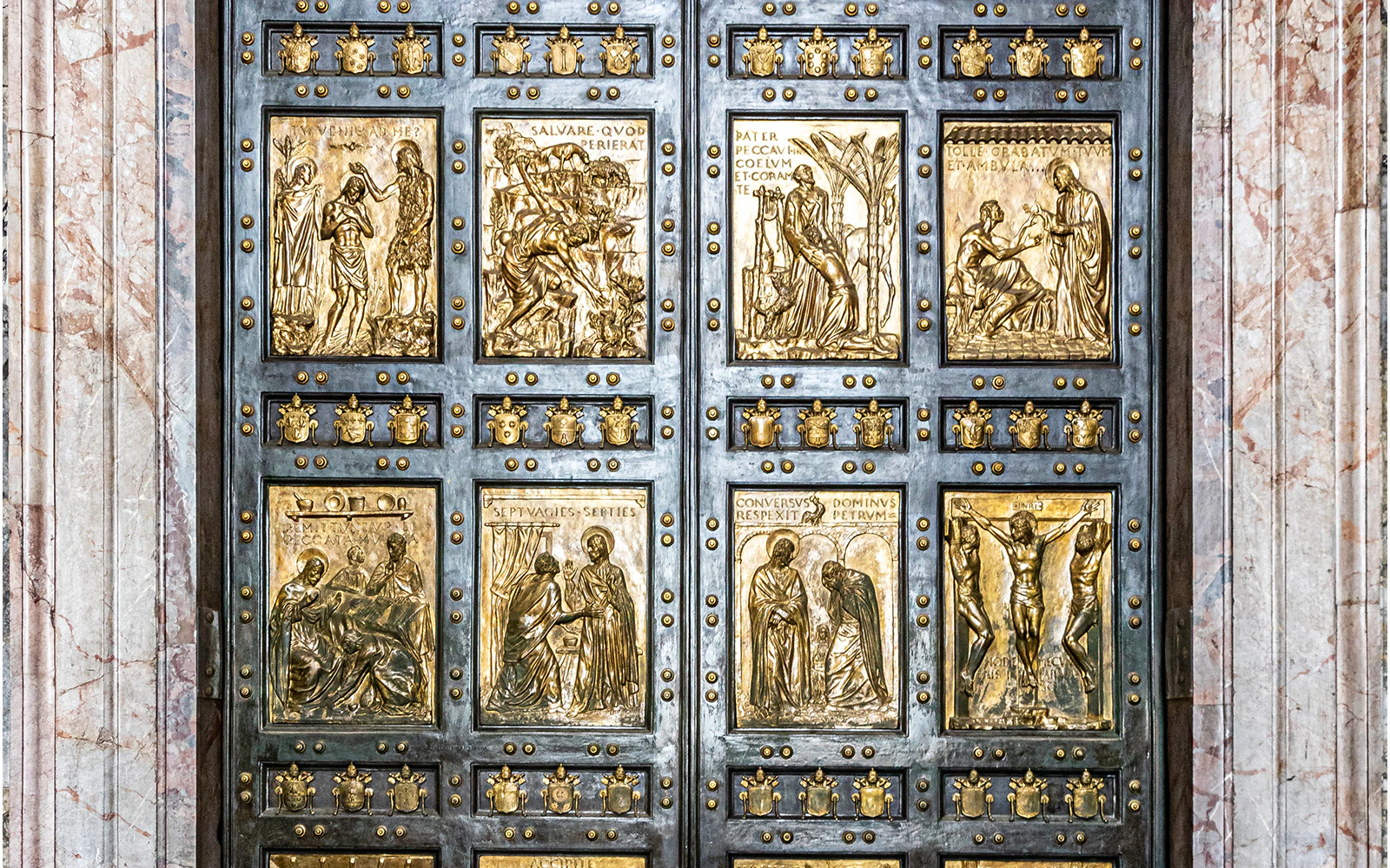 La Porta Santa at St Peter's Basilica, featuring detailed religious carvings.