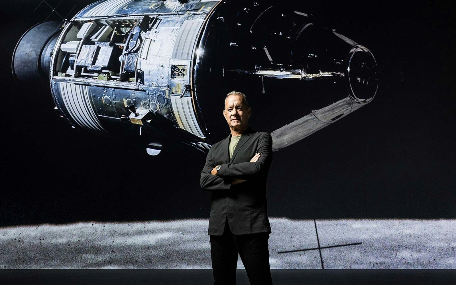Spacecraft module display with a person standing in front, related to The Moonwalkers tour.