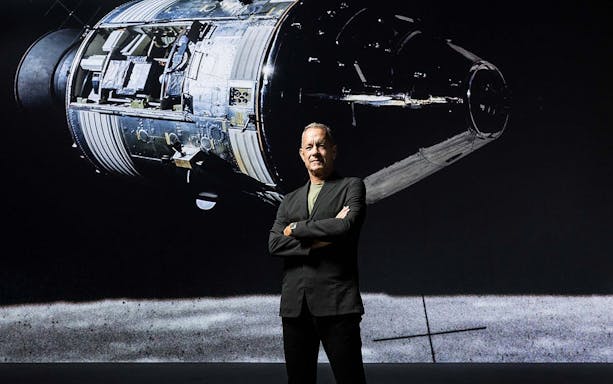 Spacecraft module display with a person standing in front, related to The Moonwalkers tour.