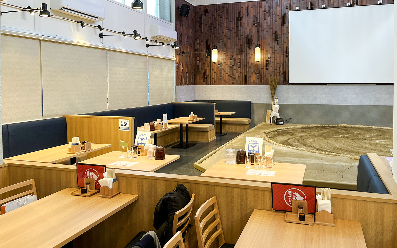 Sumo wrestling arena with dining tables in a Japanese restaurant setting.