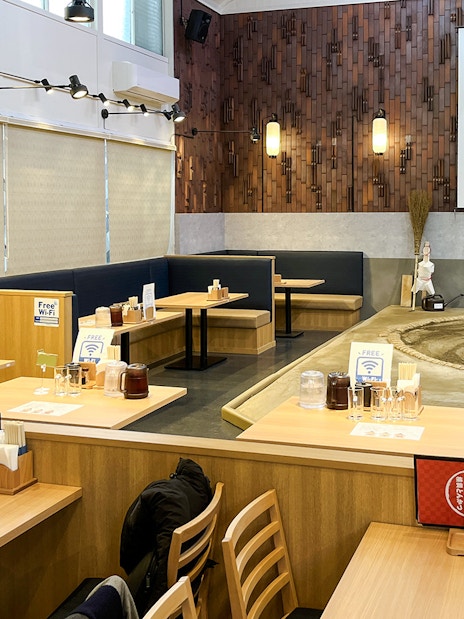 Sumo wrestling arena with dining tables in a Japanese restaurant setting.