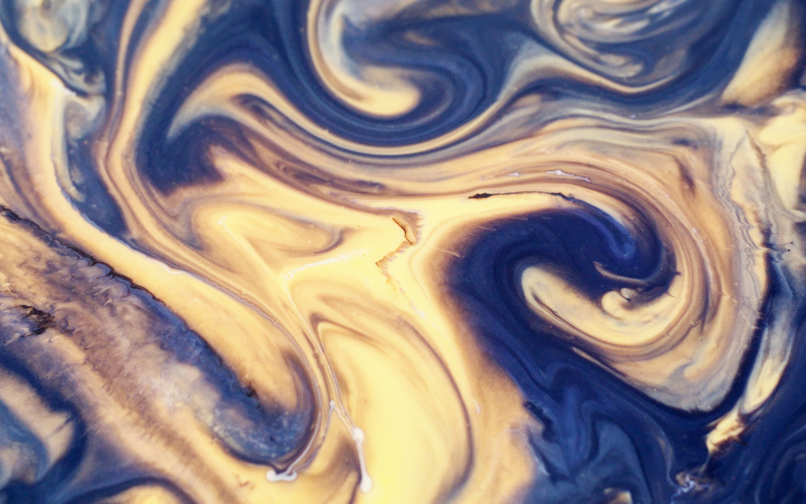 Blur blue yellow golden color chemical water marble particles enamel texture on abstract background.