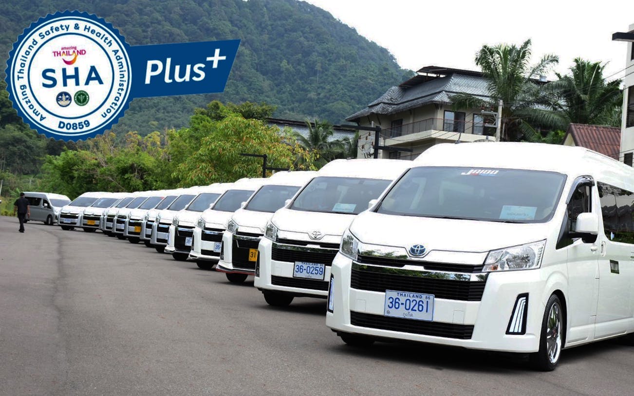 Private transfer vans lined up at Phuket Airport for hotel transport.