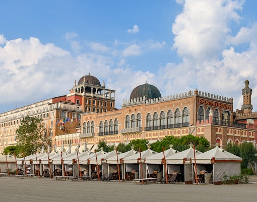 Historic building and beach cabanas at Venice Lido, near the Venice Film Festival location.