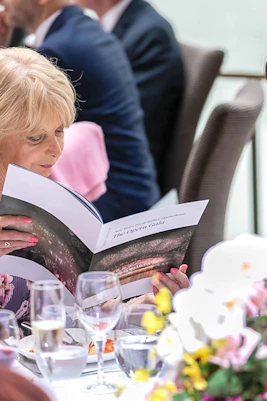 Guests reading program at NYE Opera Gala, Sydney Opera House.