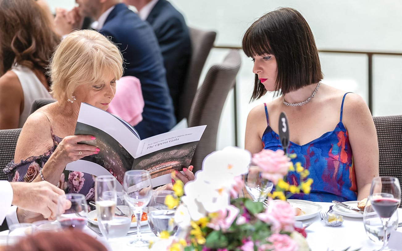 Guests reading program at NYE Opera Gala, Sydney Opera House.