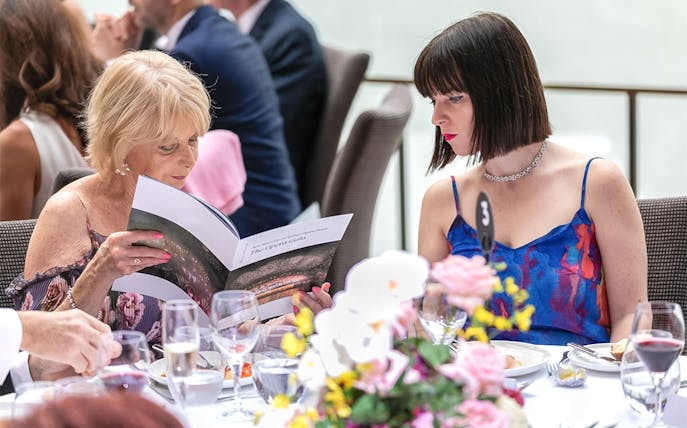 Guests reading program at NYE Opera Gala, Sydney Opera House.