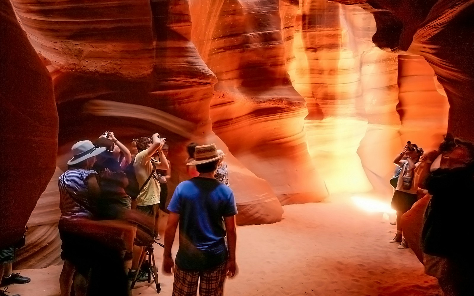 Tourists photographing the sandstone formations in Antelope Canyon, Arizona.