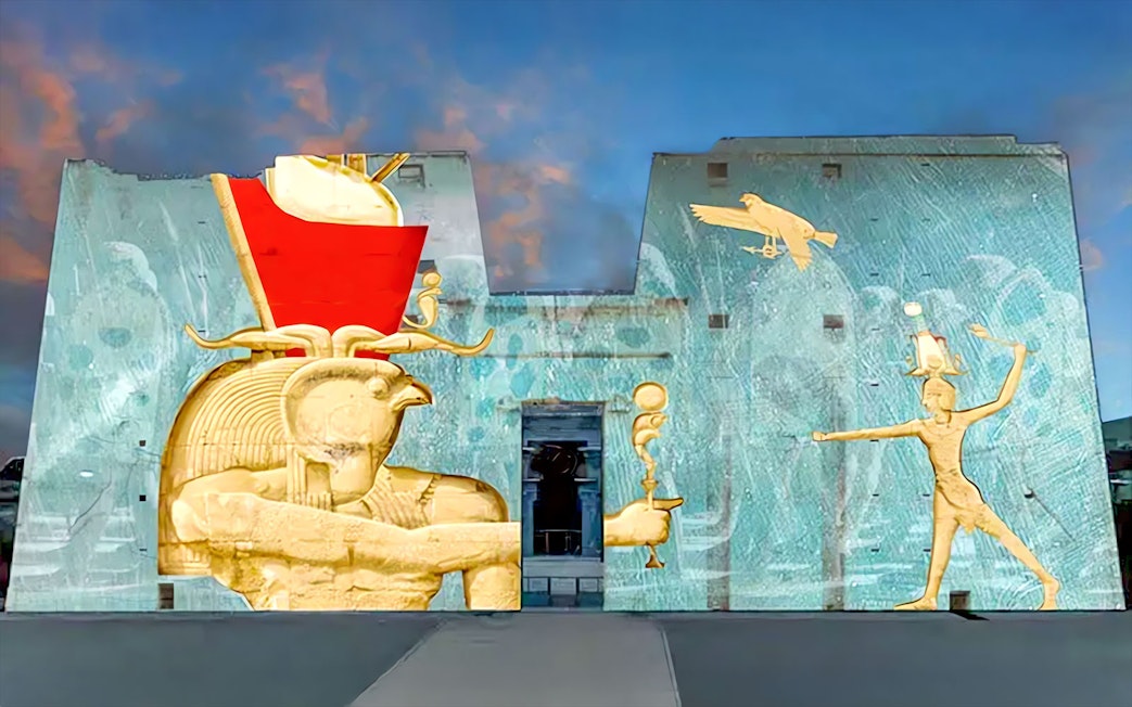 Sound and Light Show projection on Edfu Temple walls, featuring ancient Egyptian deities.