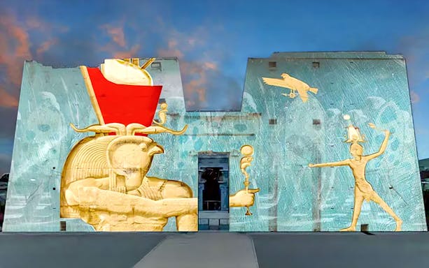 Sound and Light Show projection on Edfu Temple walls, featuring ancient Egyptian deities.
