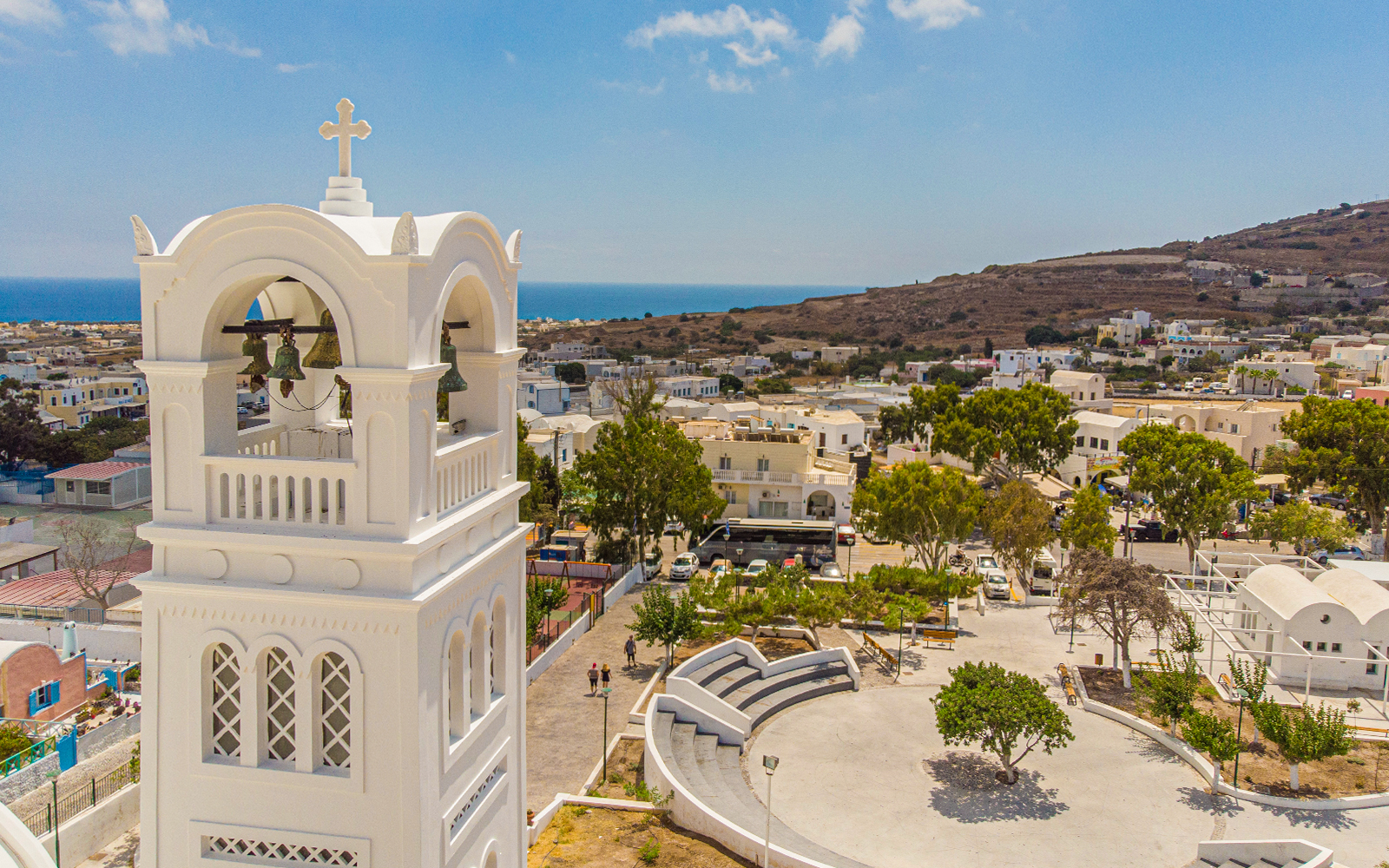 Bell tower overlooking Santorini village with sea view, part of Santorini Day Tour with Sunset in Oia.