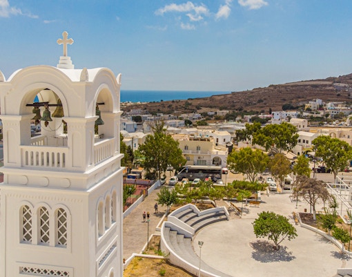 Bell tower overlooking Santorini village with sea view, part of Santorini Day Tour with Sunset in Oia.
