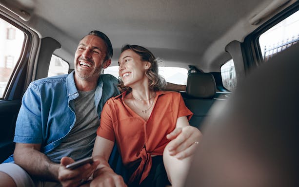 Couple enjoying a private car ride on a tour from Paris to Mont Saint-Michel and Honfleur.