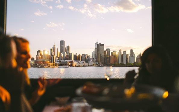 Chicago skyline view from a dinner cruise on Lake Michigan at sunset.