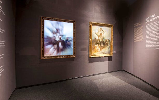 Framed artworks displayed at the iMucha Exhibition, showcasing Czech music history.